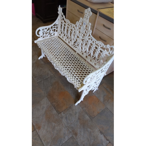 469 - Cast iron garden bench, painted white, with pierced hexagonal seat and scrolling foliate back, centr... 