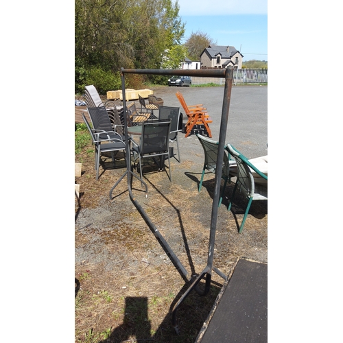 490 - Freestanding tubular steel clothes rail on splayed feet with two castors (5ft tall and 6ft wide)