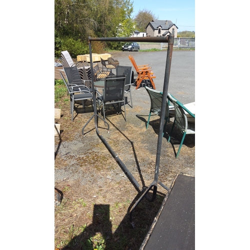 490 - Freestanding tubular steel clothes rail on splayed feet with two castors (5ft tall and 6ft wide)