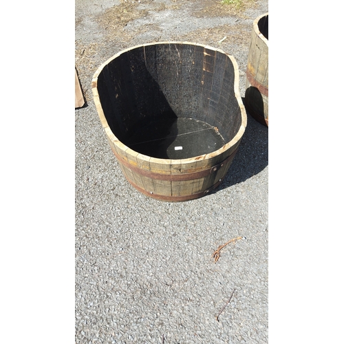 495 - Coopered timber half-barrel planter, with staved construction and two iron hoop bands.