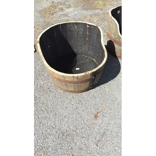495 - Coopered timber half-barrel planter, with staved construction and two iron hoop bands.