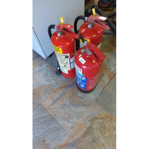 502 - A group of portable fire extinguishers, red-painted cylinders with lever handles, pressure gauges, h... 