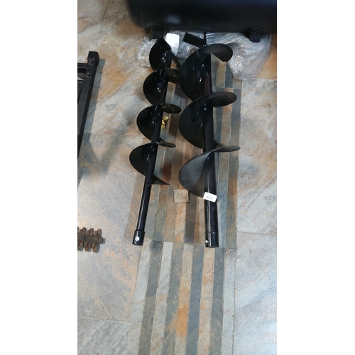 520 - A pair of black-painted steel earth auger drill bits, each with helical flights and tubular shanks t... 