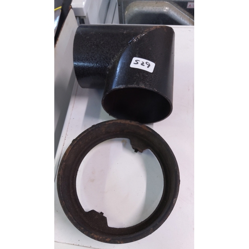 529 - A group of black metal pipe fittings comprising a T-junction and a circular collar, of heavy gauge c... 