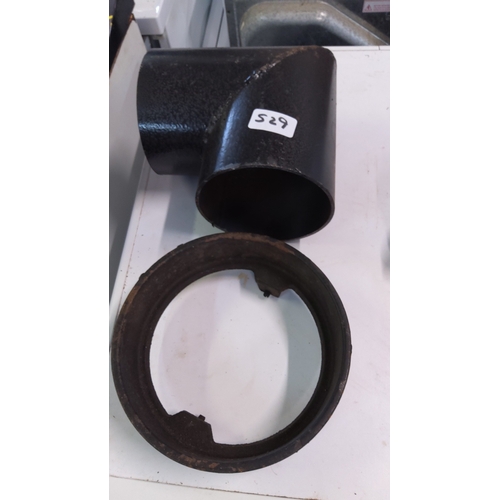 529 - A group of black metal pipe fittings comprising a T-junction and a circular collar, of heavy gauge c... 