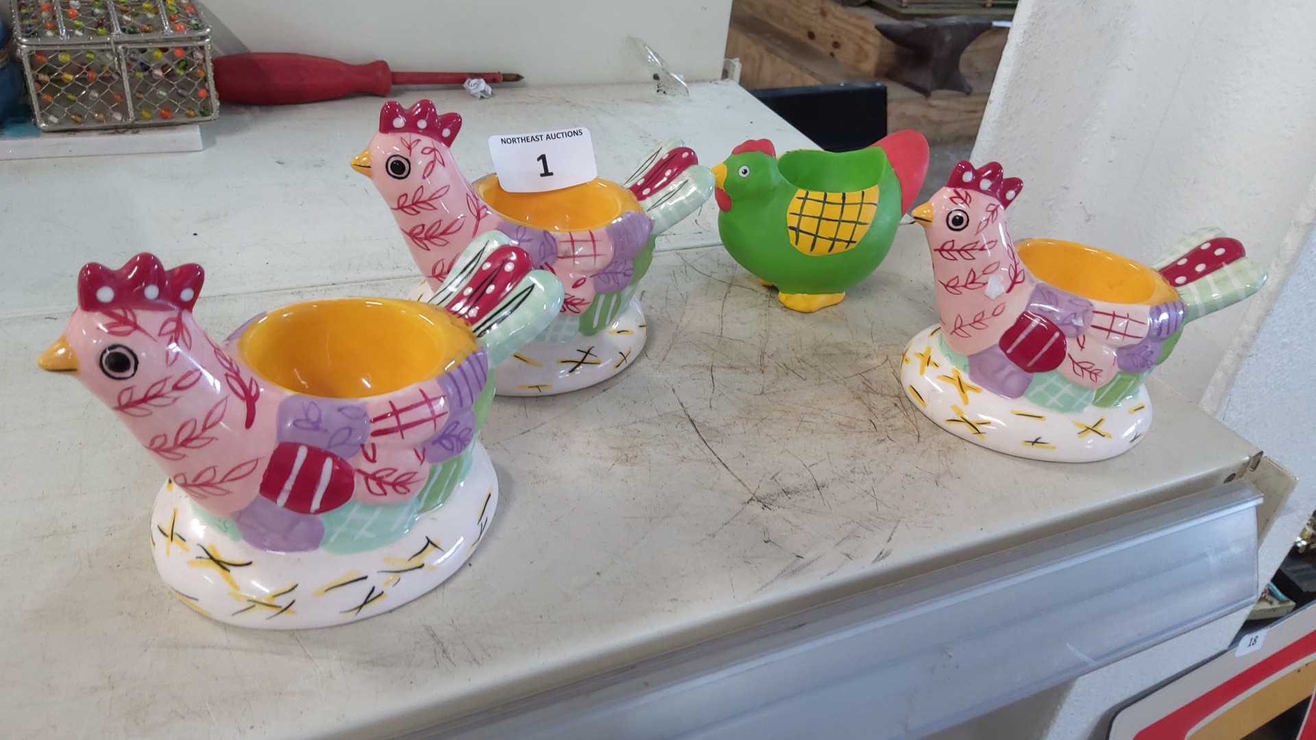 Four glazed ceramic hen-form egg cups.