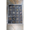 A collection of military cap badges and insignia in brass, white metal ...