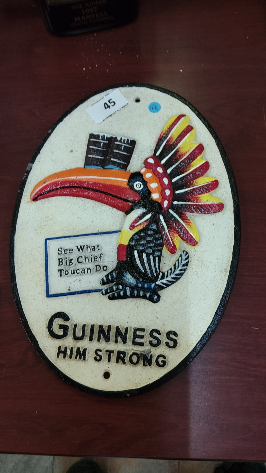 Guinness cast-iron advertising plaque of oval form, painted in relief ...