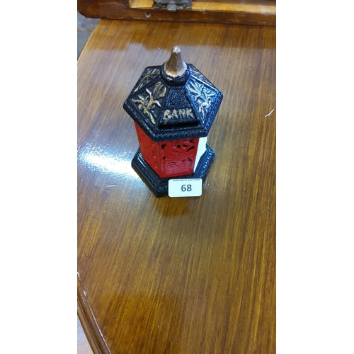 Pagoda-form cast-iron money box, painted red and black with gilt floral ...