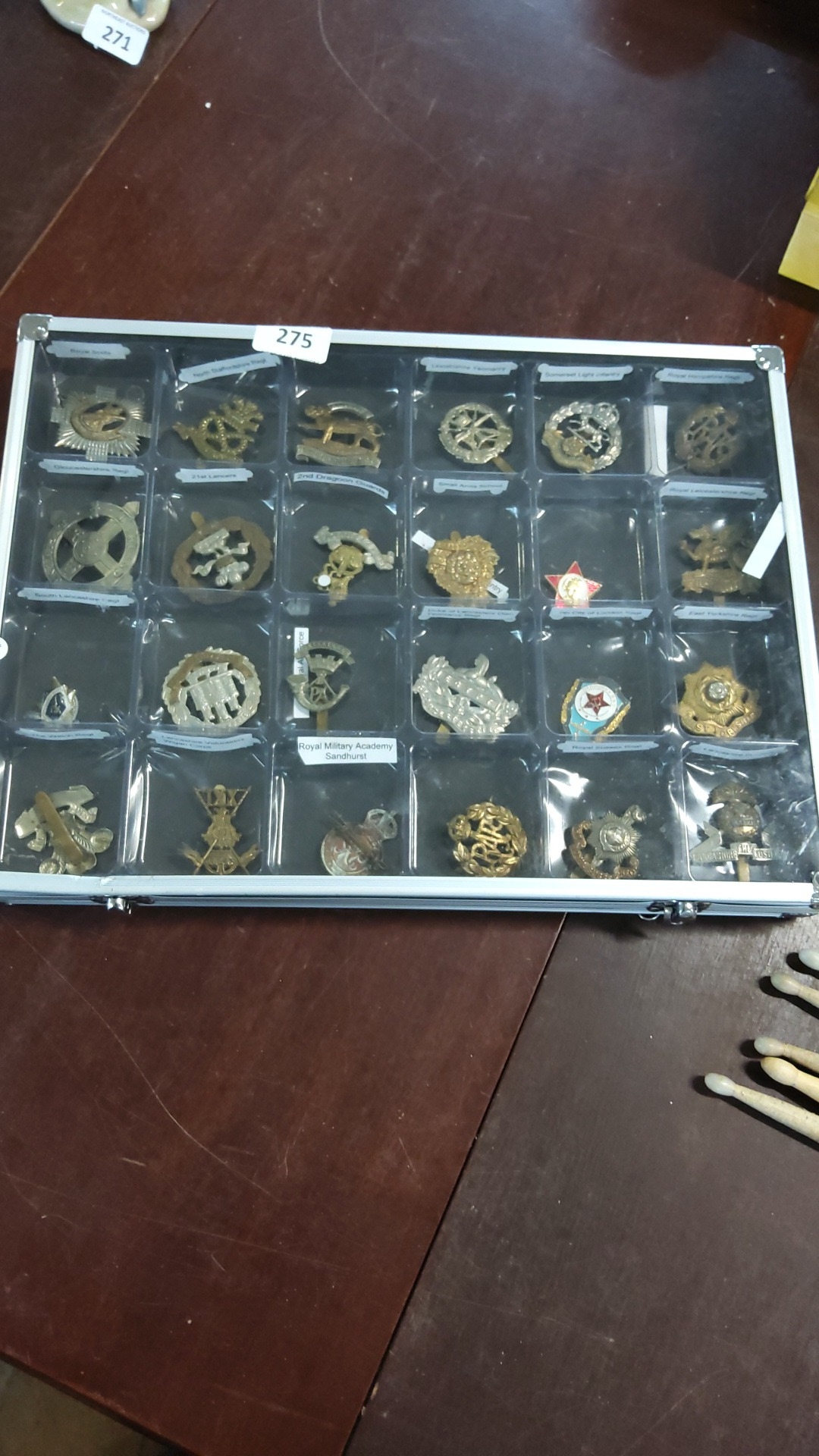 A collection of 24 British military cap badges and regimental insignia ...