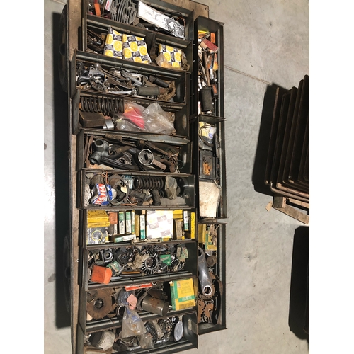 310 - Racking full of motorcycle and car spares. Including a large quantity of BSA and Triumph parts. Appr... 