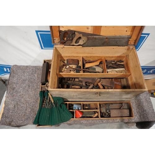 675 - Large wooden chest with assorted woodworking tools including planes, auger bits, saws etc