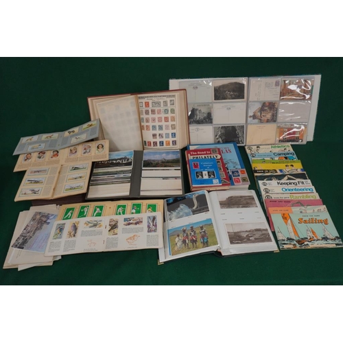 426 - Empire postage stamp album, large quantity of postcard albums, assorted cigarette cards and quantity... 