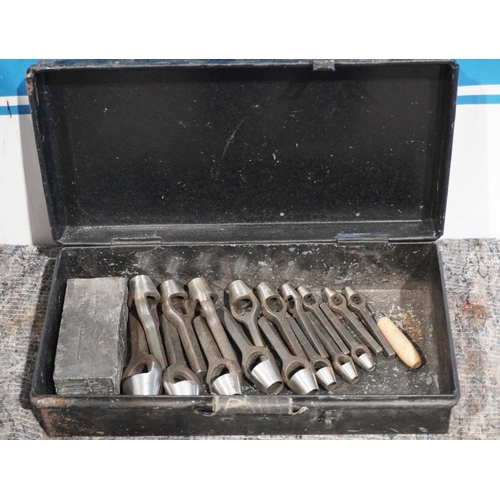 704 - Metal box containing 17 priory wad punches and lead cutting block