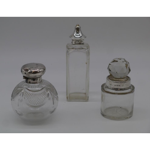 429 - 3 Glass bottles with silver tops