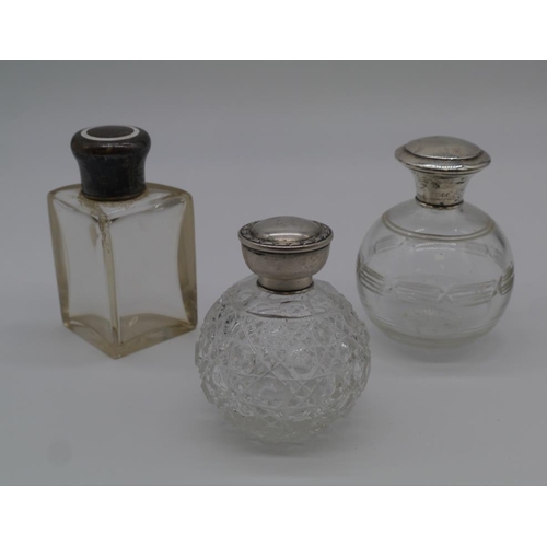 455 - Three silver topped scent bottles