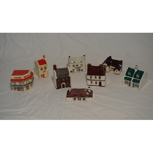 477 - 8 Assorted ceramic miniature buildings