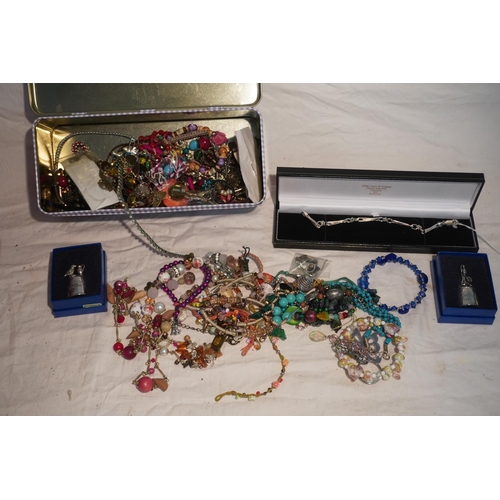 622 - Tin of costume jewellery including silver bracelet