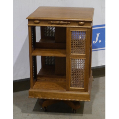 88 - Oak revolving bookcase with cane sides and casters 34x20