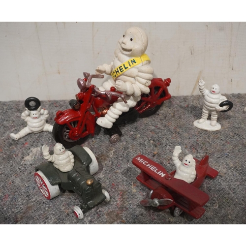868 - Cast iron Michelin man on motorbike and assorted other cast man figures