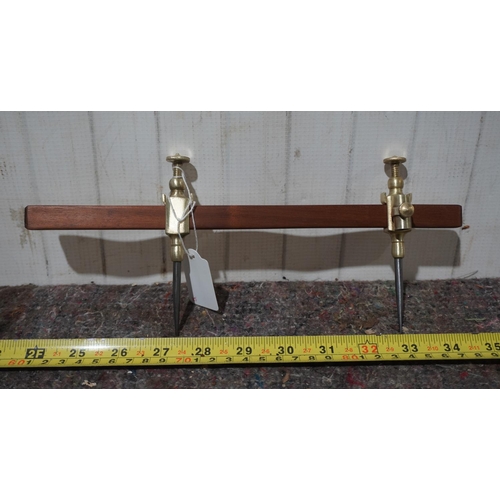 463 - Pair of brass trammels on wooden bar