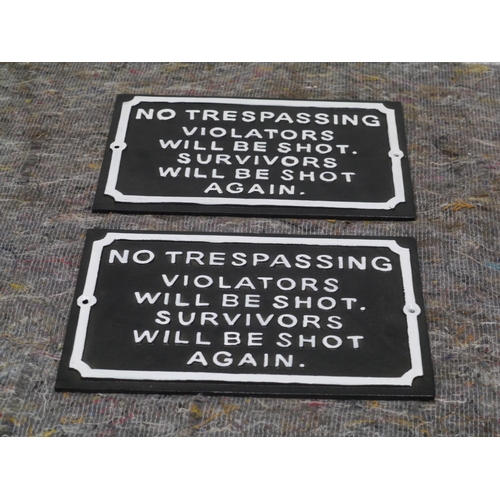 63 - 2 Cast iron no trespassing signs