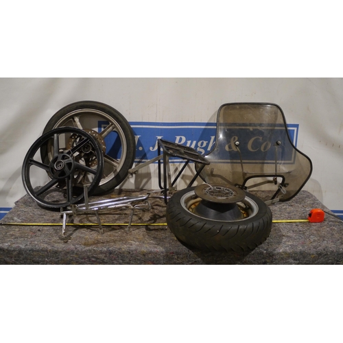 543 - 2 Kawasaki front wheels, sidecar wheel, assorted rear racks and front fairing