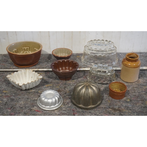 43 - Assorted jelly moulds and stone jars