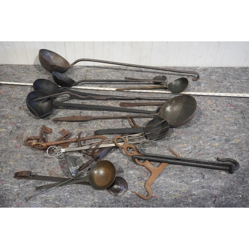 67 - Cast iron ladles and other kitchen tools