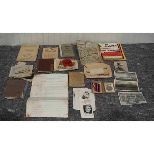 588 - WWII medal sets and military ephemira to include service books, ration books etc