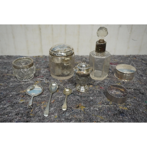 489 - Assorted silver items to include spoons, silver top jars and perfume bottles