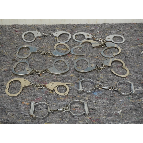 594 - 9 pairs of old police handcuffs