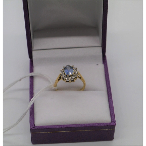 477 - 18ct Gold, diamond and blue topaz ring. Size H