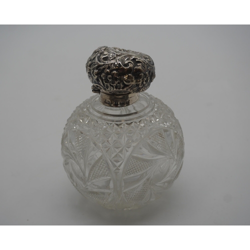 486 - Victorian cut glass perfume bottle with solid silver lid and original glass stopper 11cm high