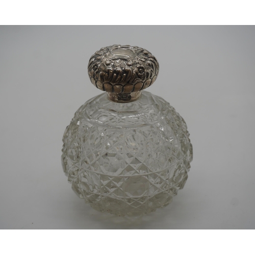 487 - Victorian cut glass perfume bottle with solid silver top 11cm high