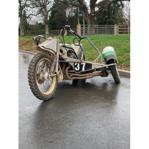 815 - Suzuki 1000cc Wasp grass track motorcycle. Fitted with side car c/w spare parts. No docs