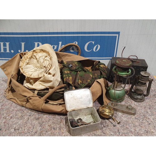 413 - Bag of old military clothing, old signal generator, hurricane lamp etc