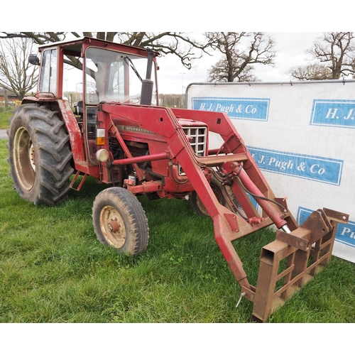 1335 - International 674 tractor with cab and loader. 2810hrs recorded c/w front forks