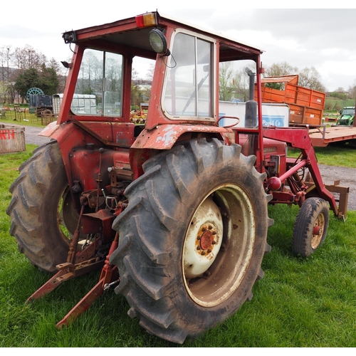 1335 - International 674 tractor with cab and loader. 2810hrs recorded c/w front forks