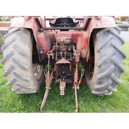 1335 - International 674 tractor with cab and loader. 2810hrs recorded c/w front forks