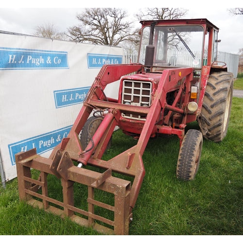 1335 - International 674 tractor with cab and loader. 2810hrs recorded c/w front forks