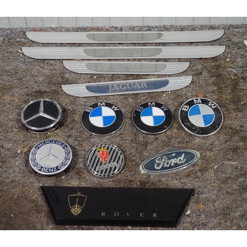 236 - Assorted car badges to include BMW, Mercedes and Jaguar