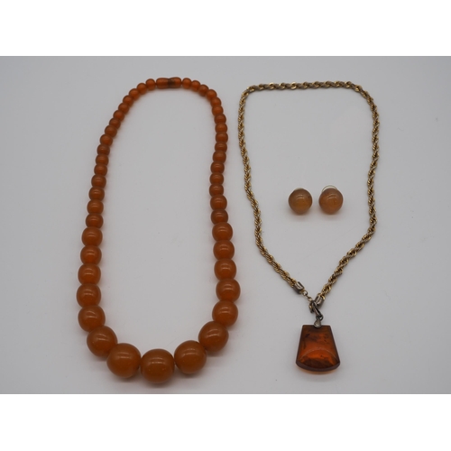 270 - Amber pendant with fool mount on yellow metal chain, amber earrings and beaded necklace