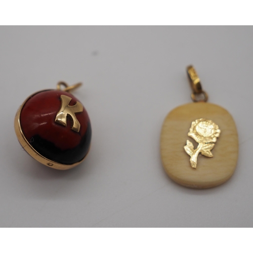 260 - 18ct Gold bone pendant and ball pendant in 18ct setting