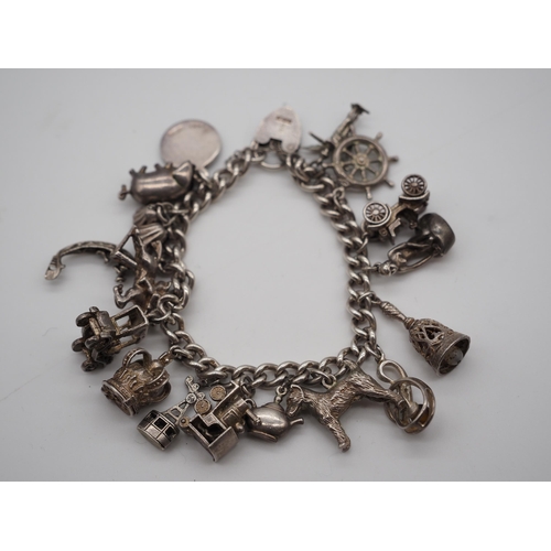 273 - Hallmarked silver charm bracelet. Approx 72g