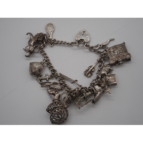 369 - Silver charm bracelet, some charms open approx 55g