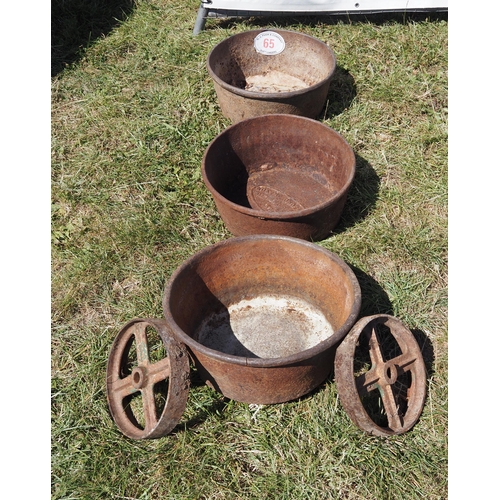 65 - 3 Cast iron circular trugs and 2 wheels