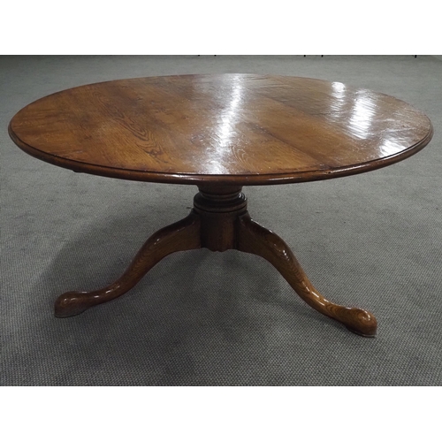 72 - Oak circular top dining table supported by a turned column and 3 swept legs 59