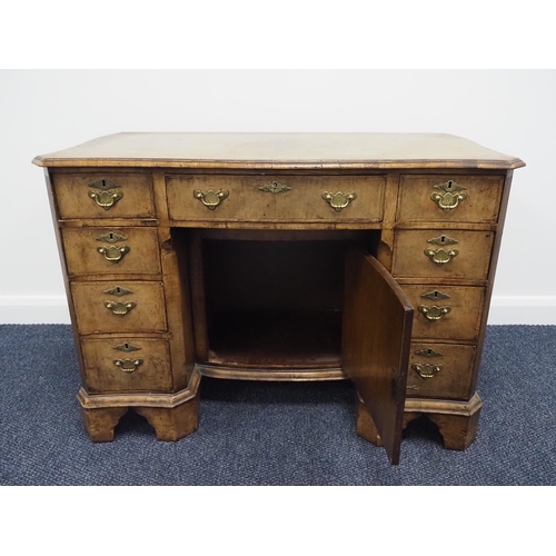 61 - Ladies walnut kneehole desk with 9 drawers, 1 cupboard, serpentine front and on bracket feet 43