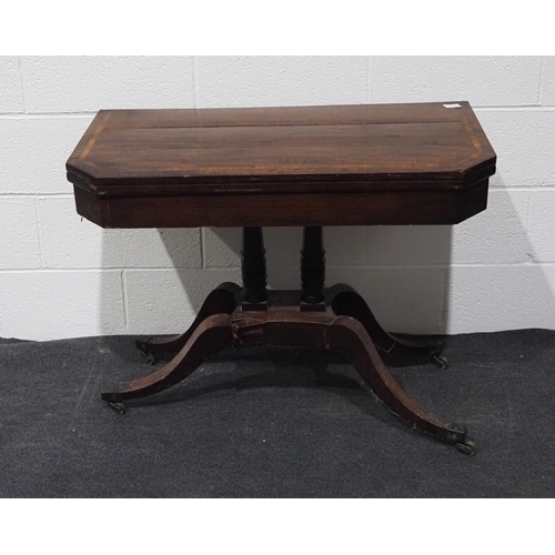 154 - Victorian mahogany swivel top folding games table with inlay, pedestal base and on brass casters 36